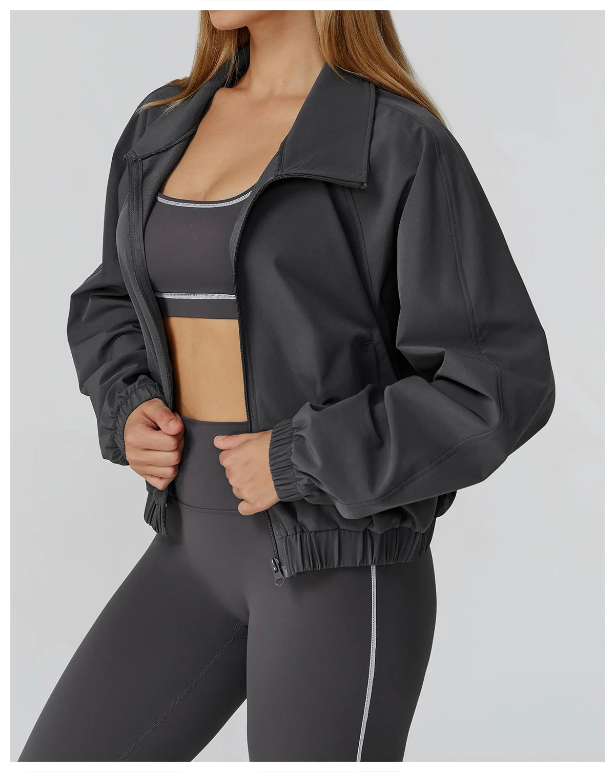 Xooie Fit women's windproof fitness jacket in black, perfect for workouts and outdoor activities