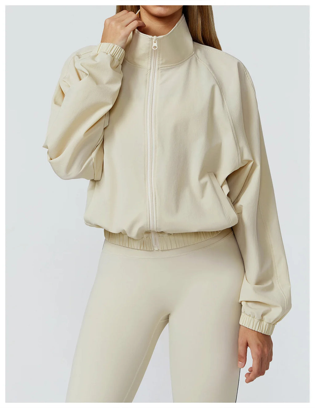 Xooie Fit women's windproof fitness jacket in light beige with a zip-up front and comfortable fit