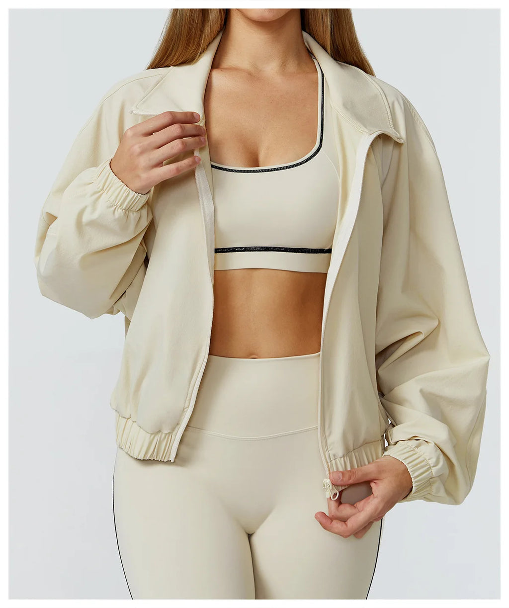 Women's windproof fitness jacket by Xooie Fit in cream color for active outdoor use