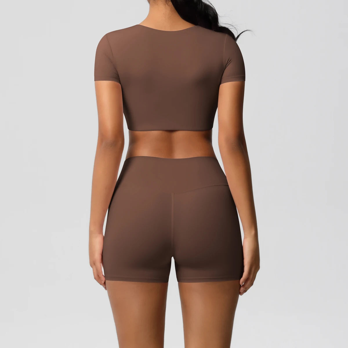 Xooie Fit women's workout crop top and shorts set in brown, shown from back view