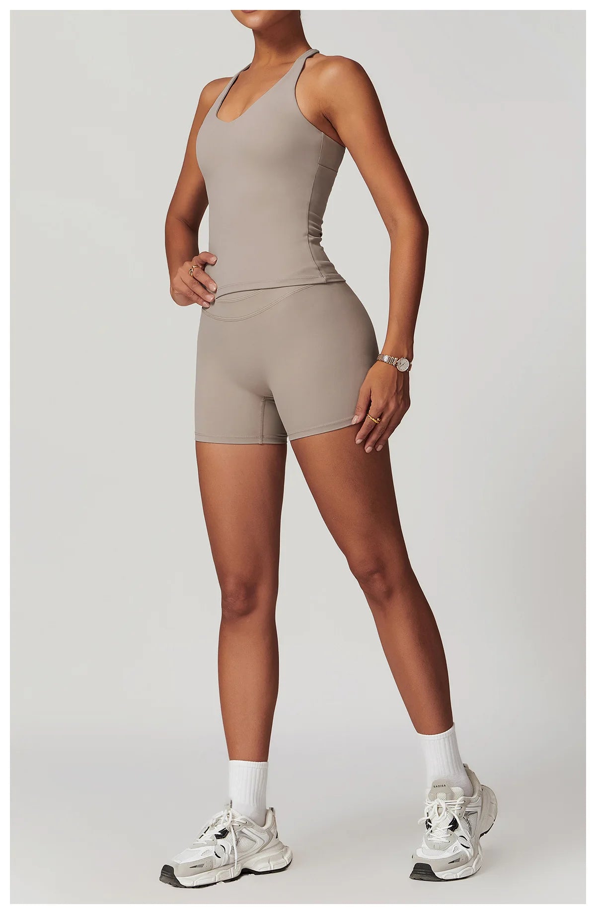 Xooie Fit womens workout set consisting of a fitted tank top and high-waisted shorts in taupe