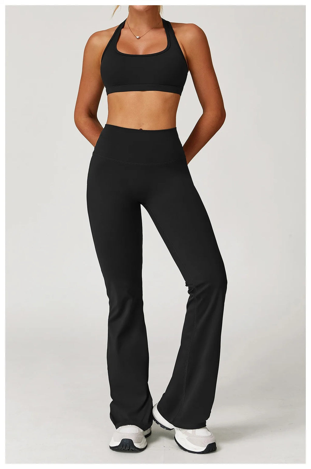 Xooie Fit women's workout set flared pants in black with matching sports bra and white sneakers2