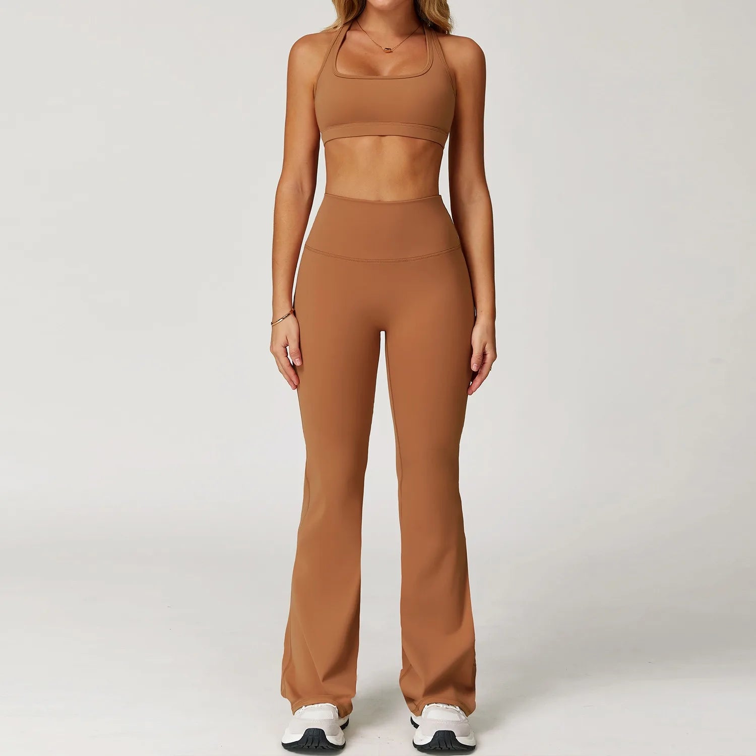 Xooie Fit women's workout set flared pants in brown with matching sports bra and white sneakers