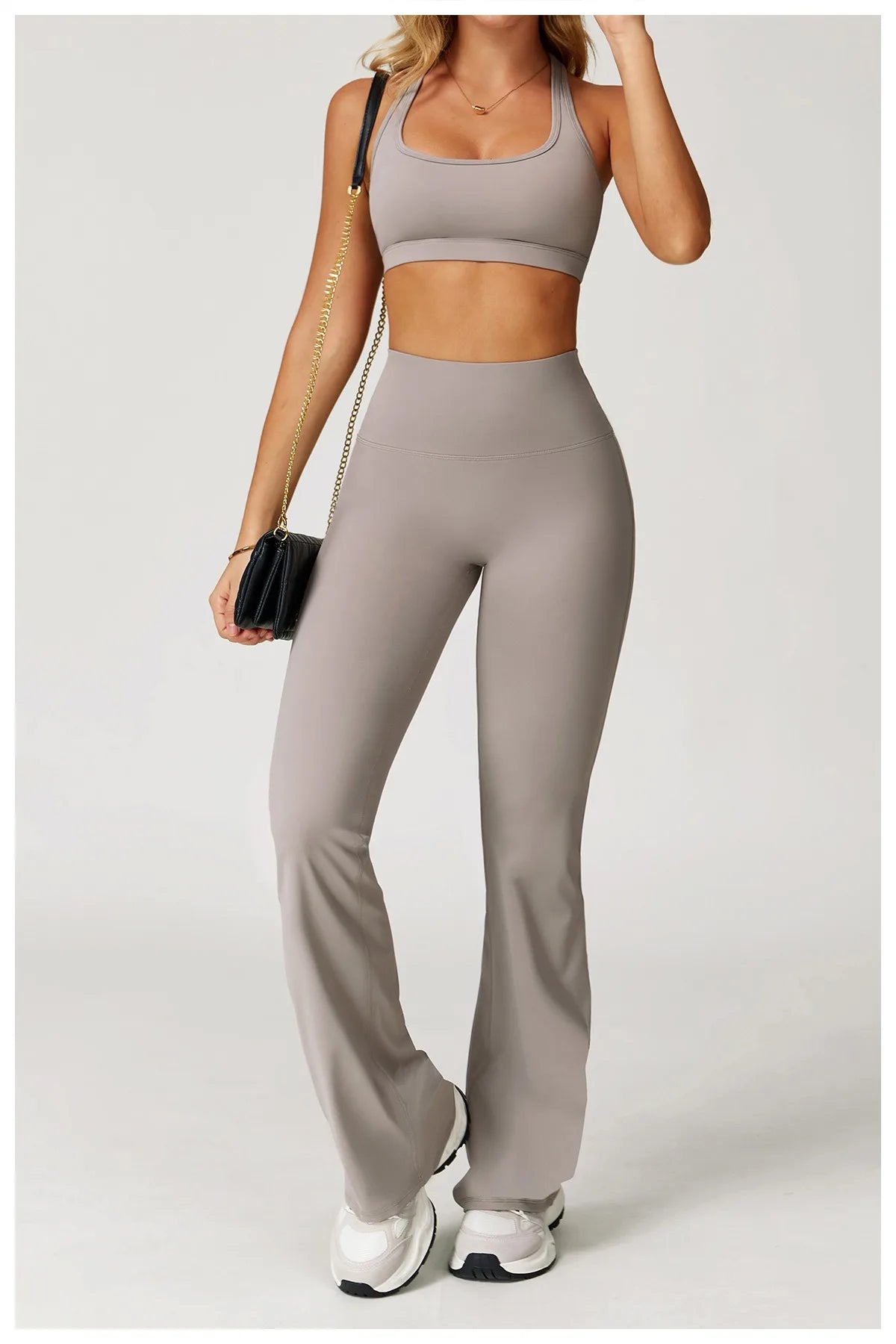 Xooie Fit women's workout set flared pants in taupe with matching crop top and white sneakers