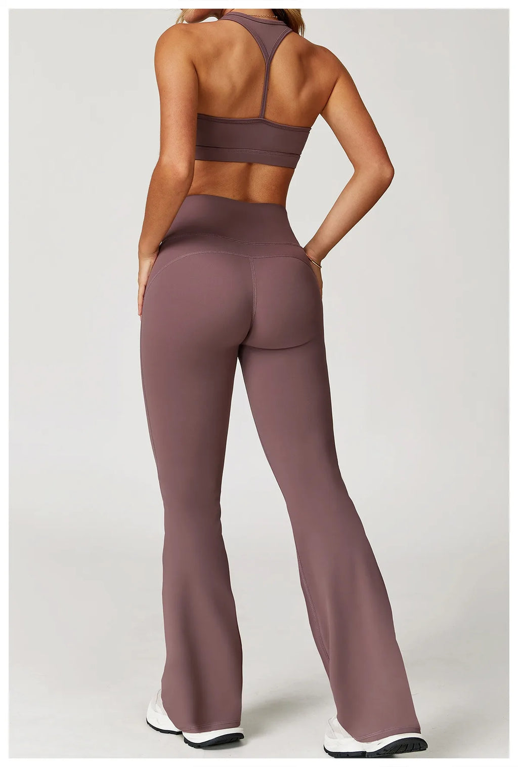 Xooie Fit women's workout set flared pants in mauve shown from the back with matching sports bra