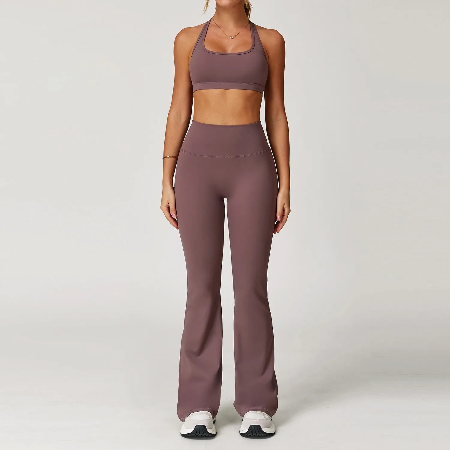 Xooie Fit women's workout set flared pants in mauve with matching sports bra and white sneakers