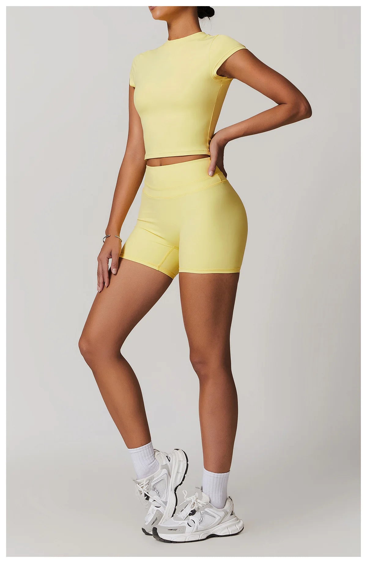 Xooie Fit womens workout set in yellow two-piece with cropped top and high-waist shorts