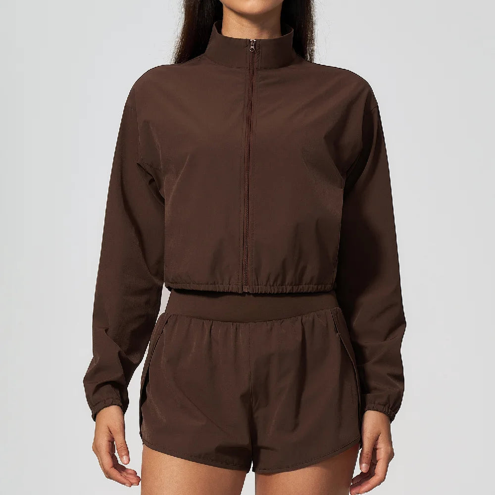 Dark brown zip-up windbreaker jacket with high neck and matching drawstring shorts set