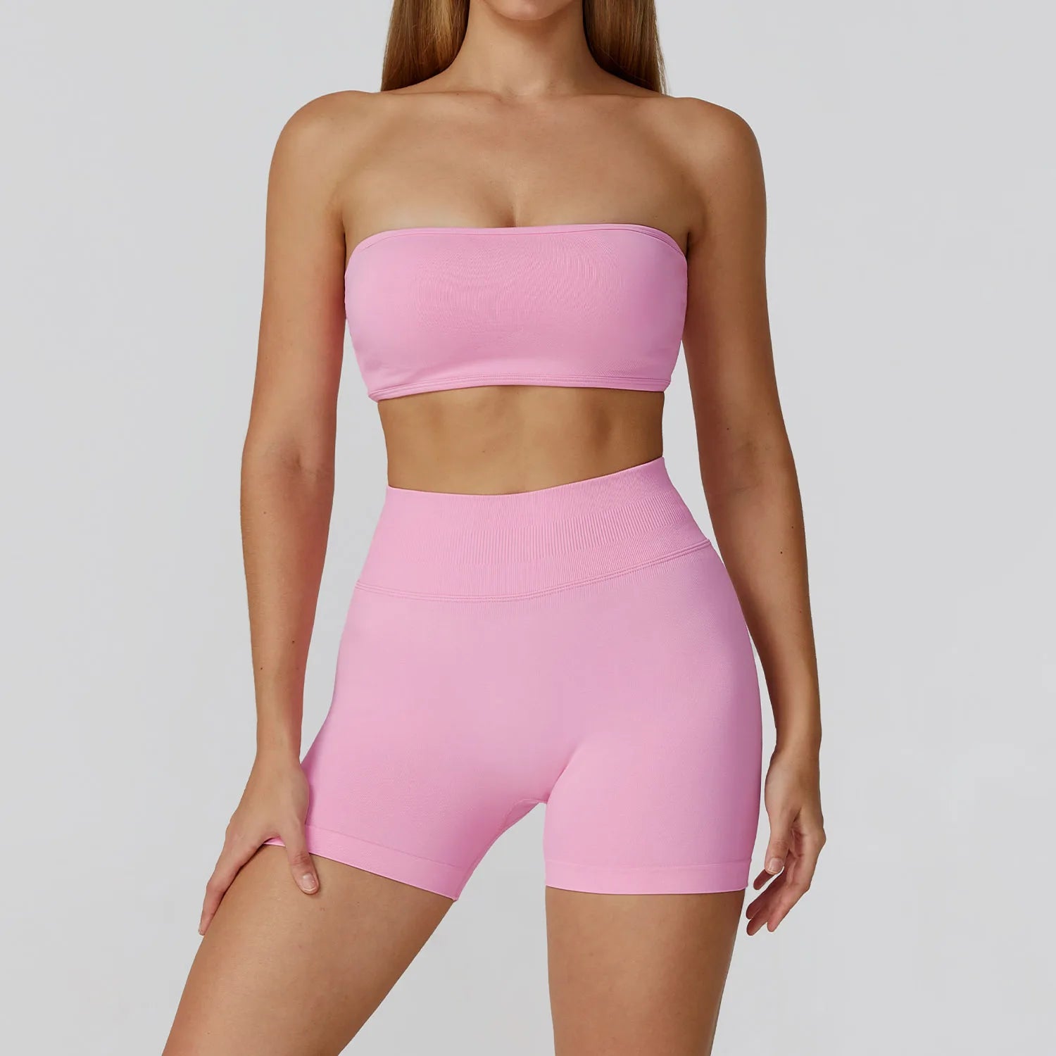 Xooie Fit strapless workout set for women in pink featuring a bandeau top and high-waisted shorts