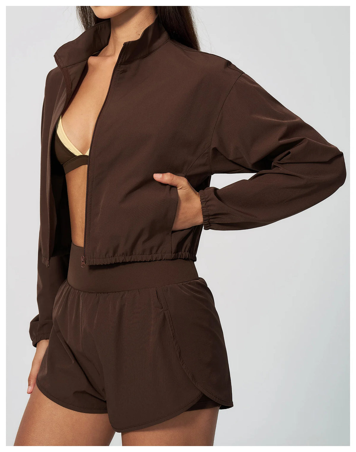 Brown zip-front long-sleeve sports jacket with elastic cuffs and matching shorts