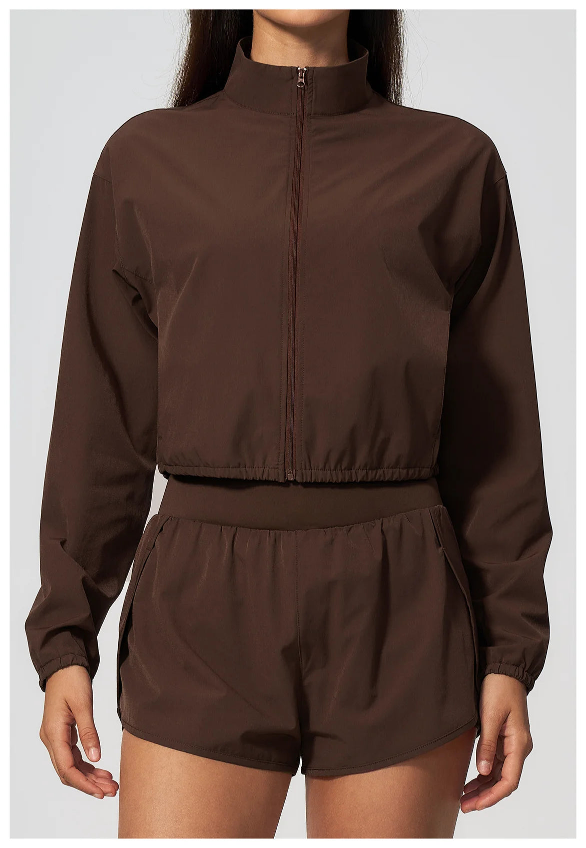Brown zip-front long-sleeve sports jacket with matching high-waist shorts set