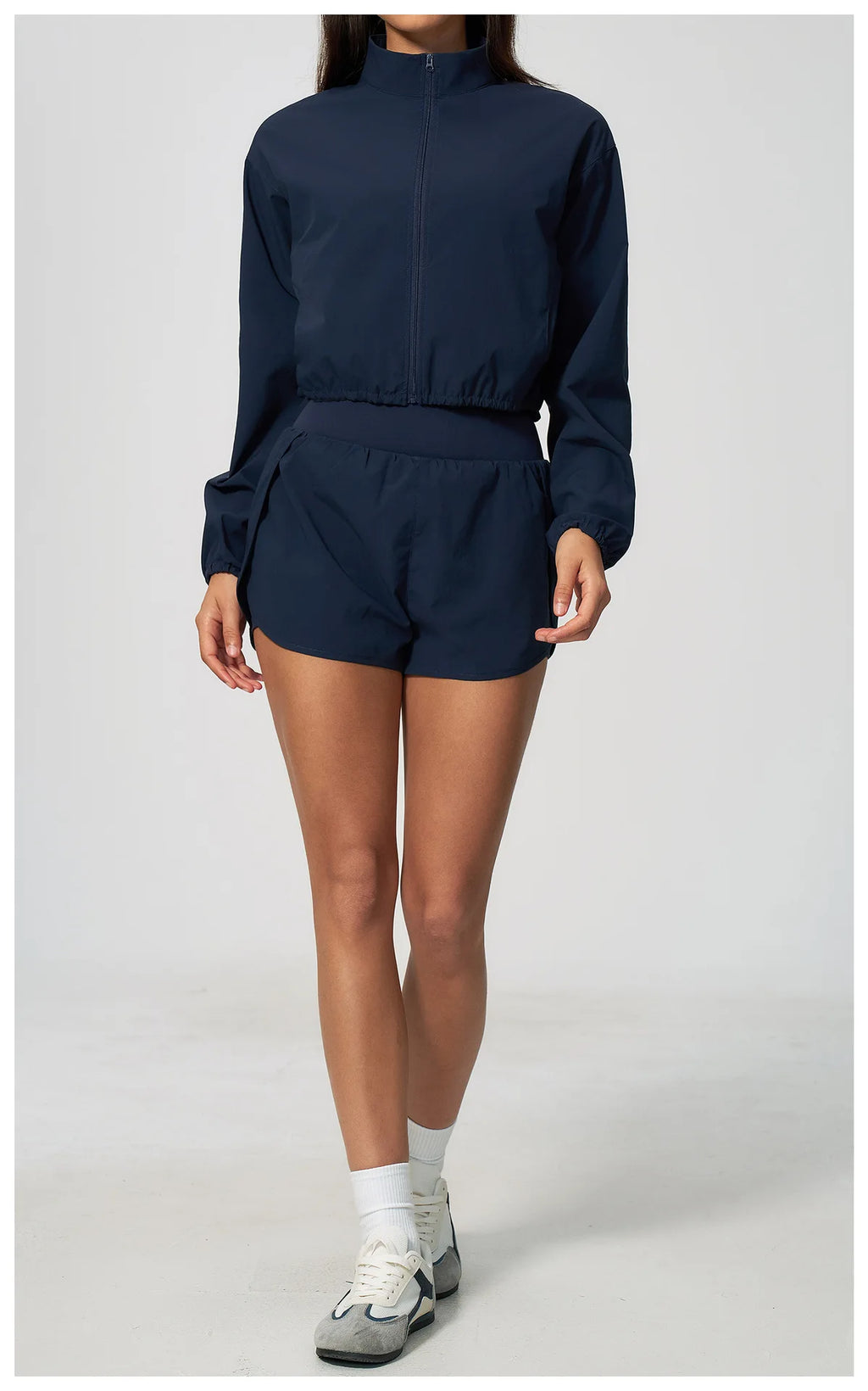 Navy zip-up long-sleeve sports jacket with matching high-waist shorts set