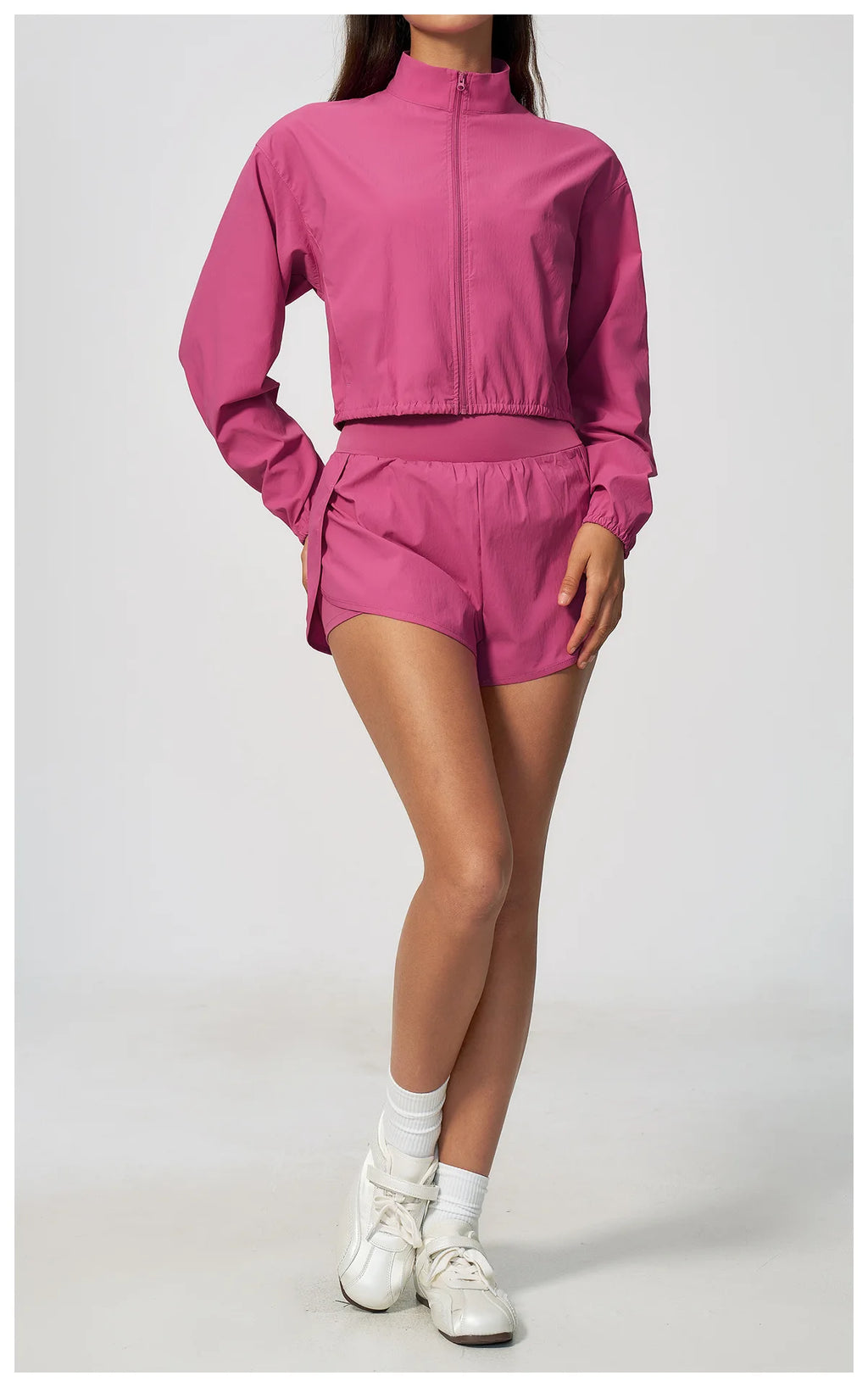 Pink zip-up cropped jacket with stand collar and elastic waist, matching shorts