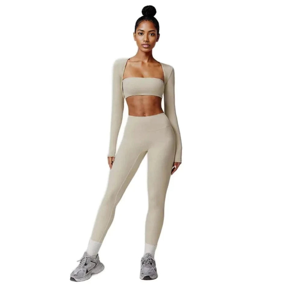 Xooie Fit 3-piece workout outfit in beige, featuring a crop top, long sleeves, and leggings for active comfort