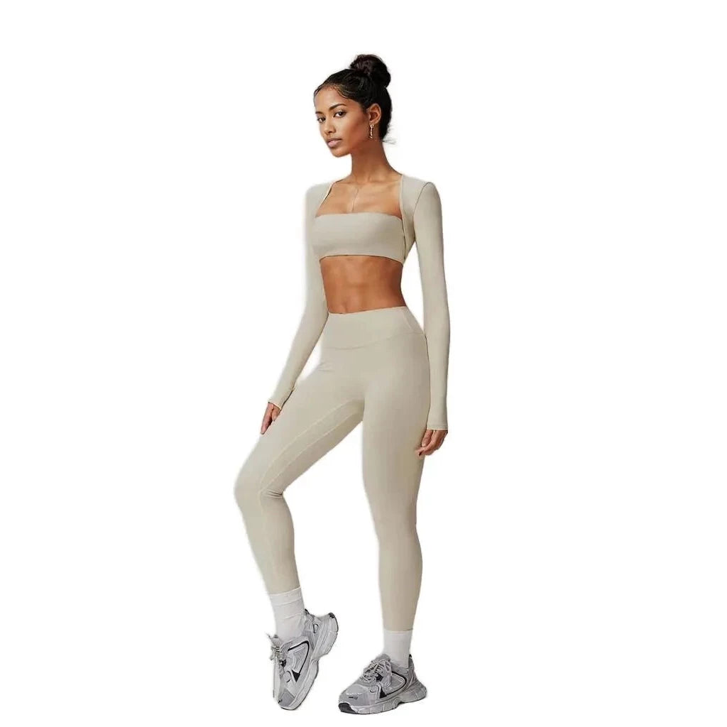 Xooie Fit 3-piece workout outfit in beige featuring a long-sleeve top, crop top, and leggings for active wear.