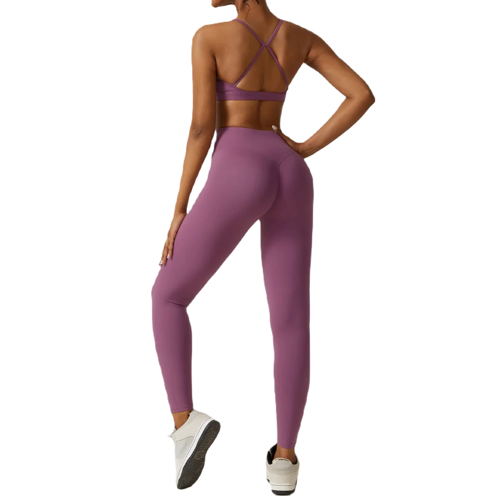 Back view of women's fitness three-piece set in purple, featuring a stylish sports bra and leggings