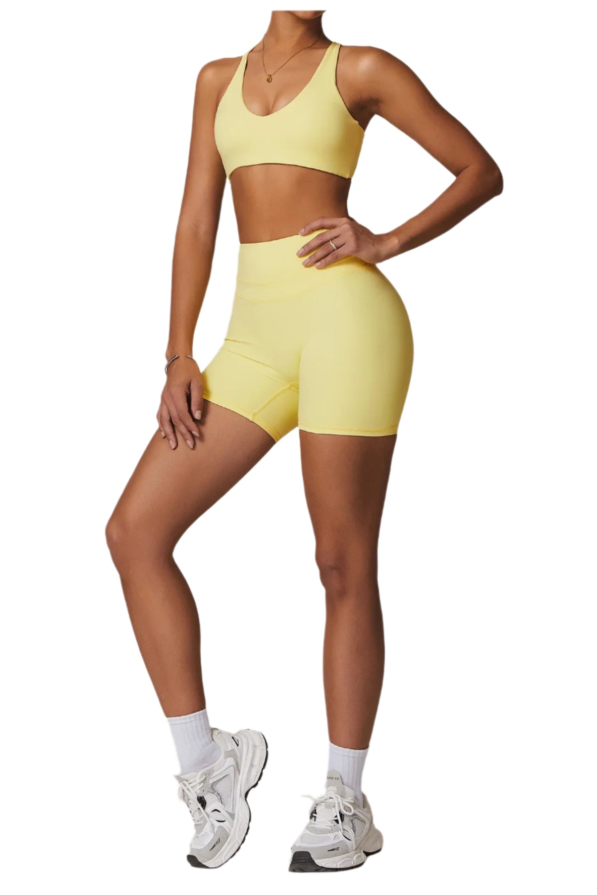 Xooie Fit women's fitness two-piece set in yellow featuring a supportive bra and high-waisted shorts