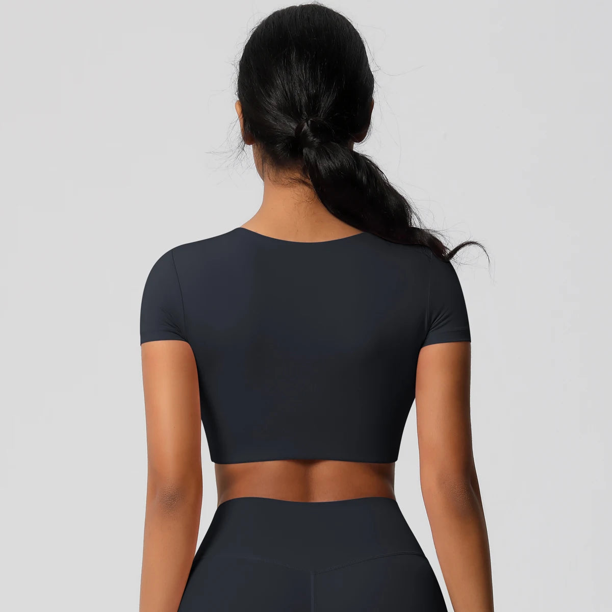 Back view of Xooie Fit yoga crop top t-shirt in black, perfect for yoga and activewear