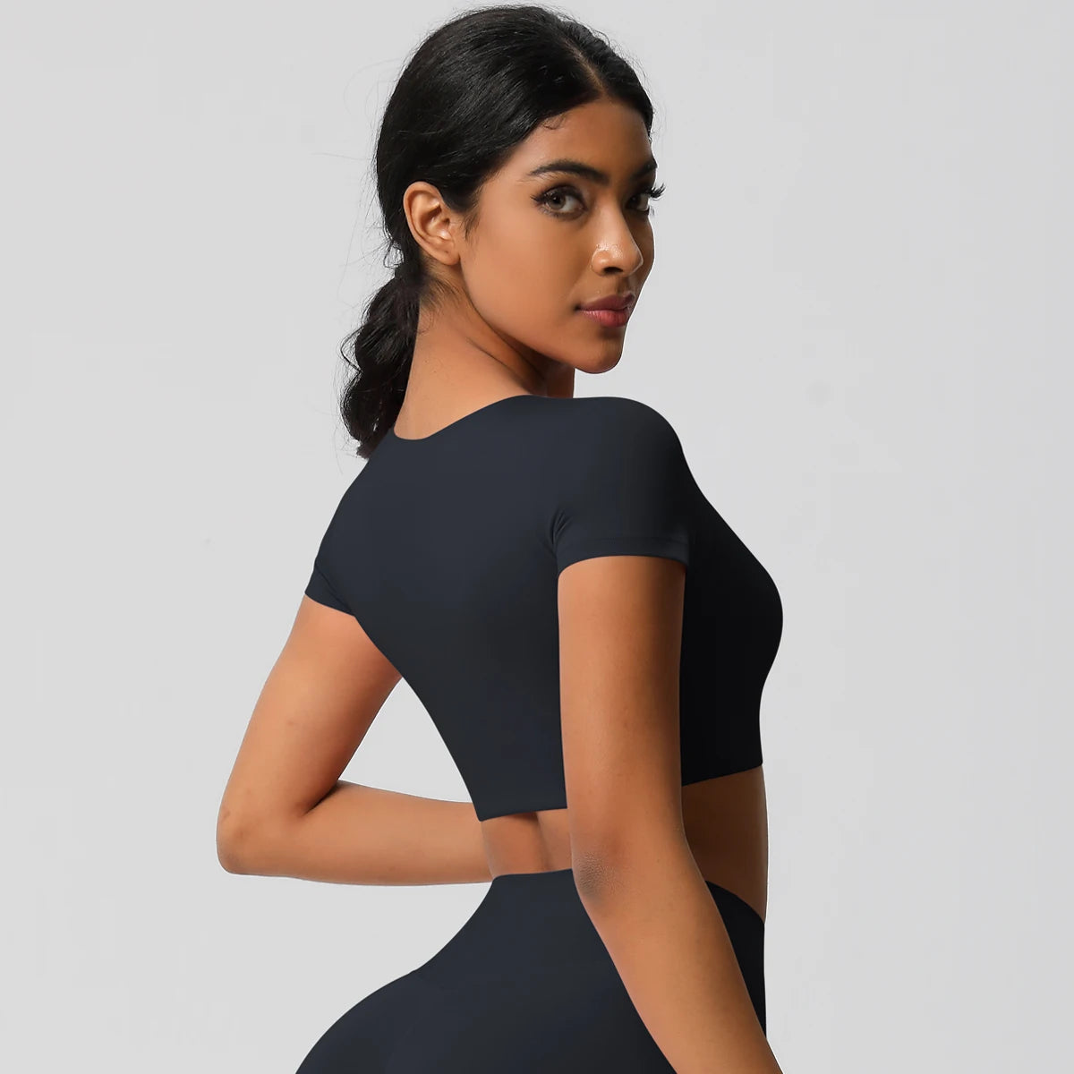 Xooie Fit yoga crop top t-shirt in black, designed for comfort and flexibility during yoga practice