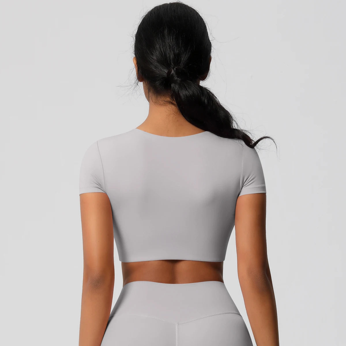 Light gray yoga crop top t-shirt with a comfortable fit, ideal for workouts and casual wear