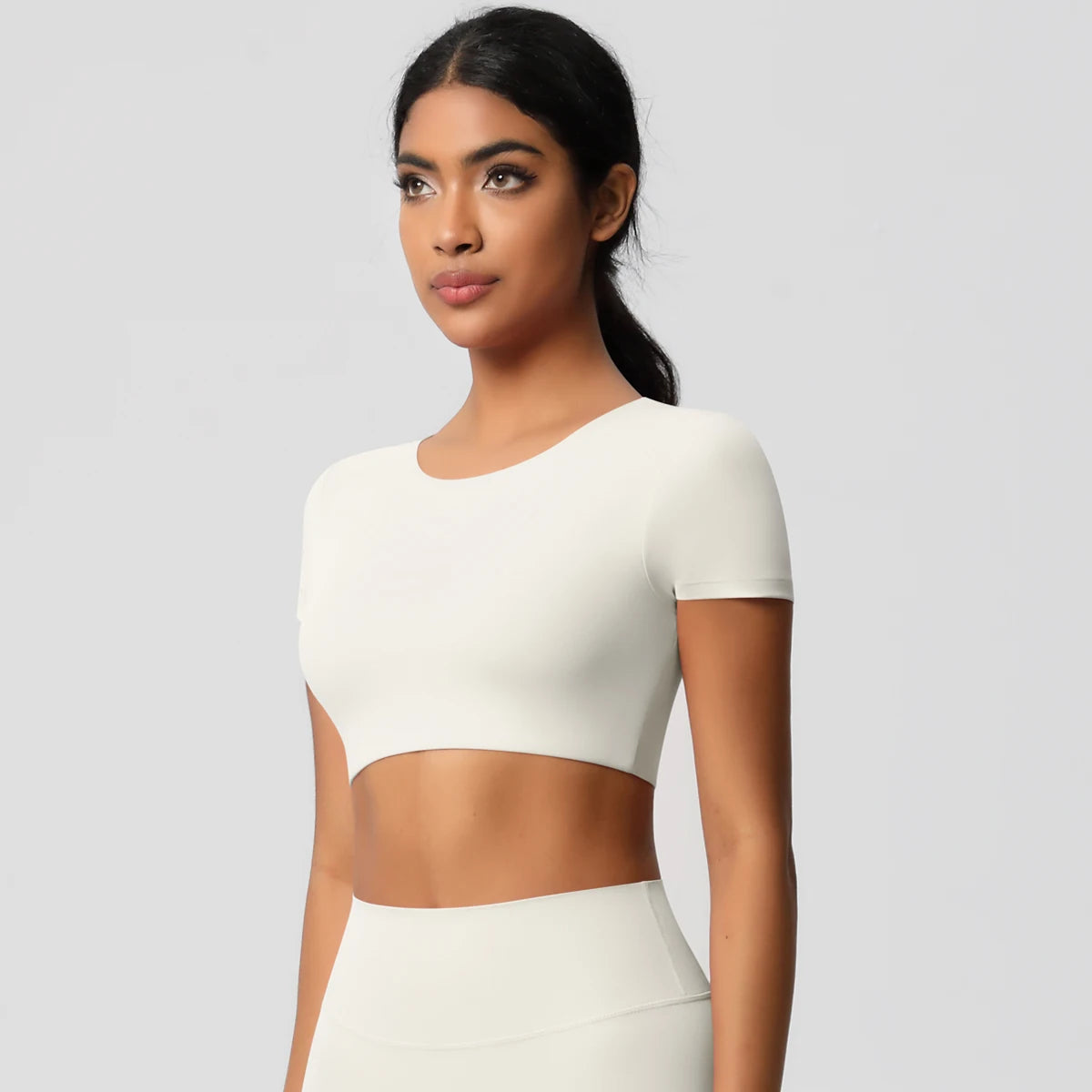 Xooie Fit yoga crop top t-shirt in white, featuring a short sleeve and fitted design for comfort during workouts