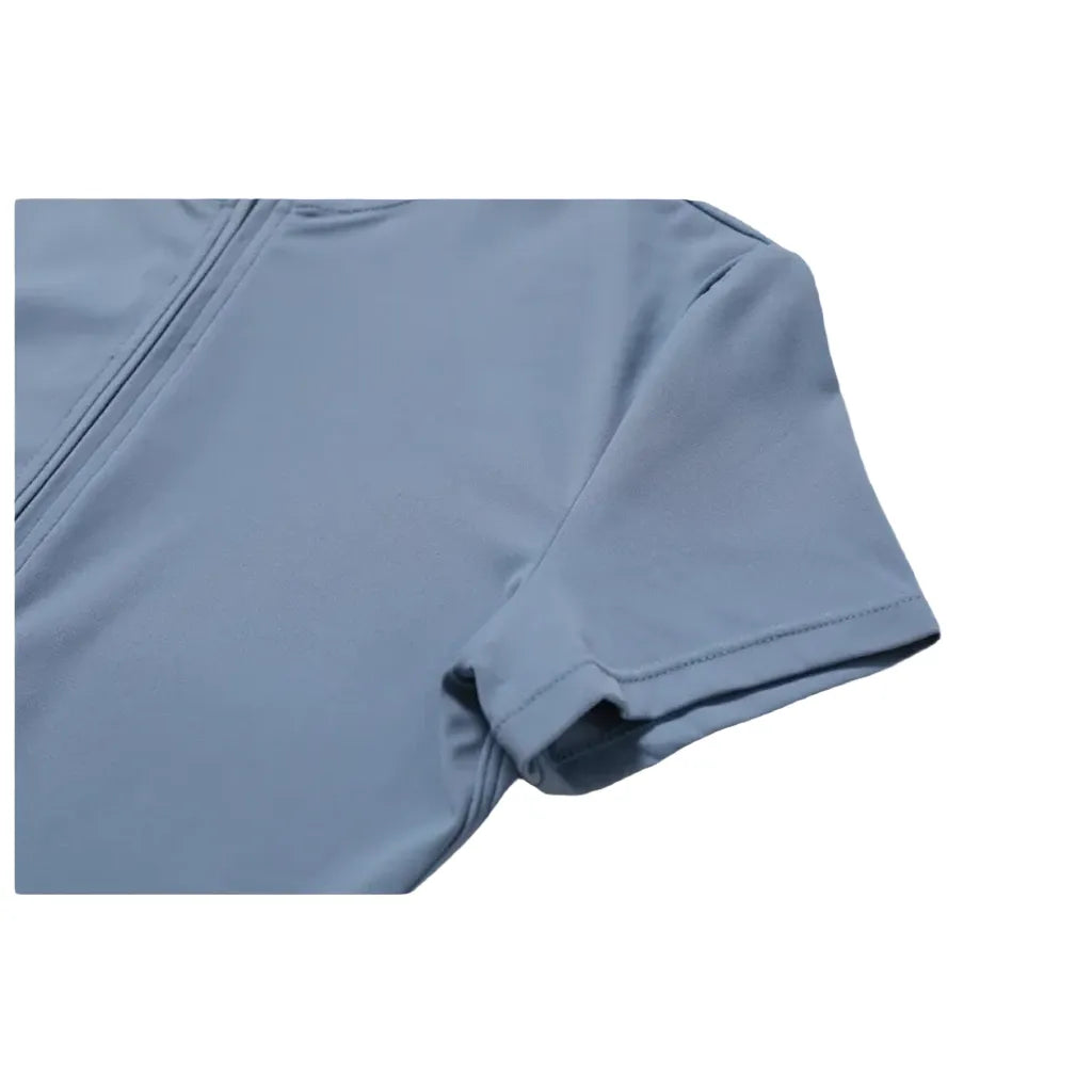 Xooie Fit zipper workout jumpsuit in light blue with a stylish half-zip design for comfort and performance back sleeve
